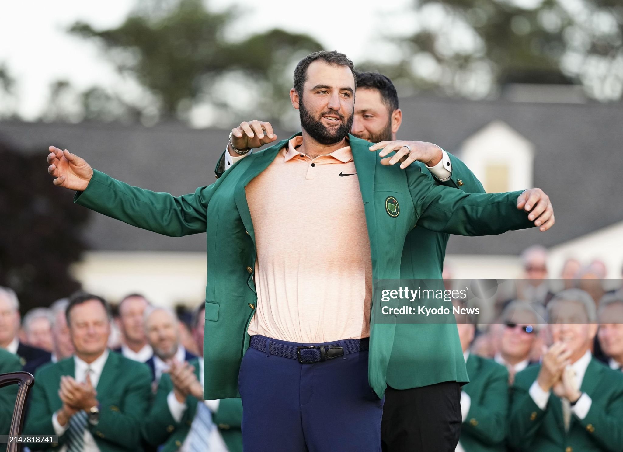 New Masters champion Scottie Scheffler (front) of the United States puts on his green jacket, given to him by last year's winner Jon Rahm of Spain, during a ceremony at Augusta National Golf Club in Augusta, Georgia, on April 14, 2024. (Photo by Kyodo News via Getty Images)
