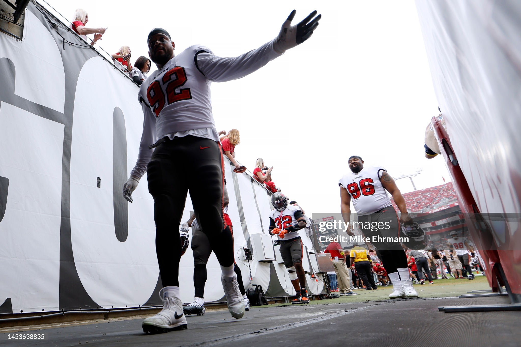 TAMPA, FLORIDA - JANUARY 01: William Gholston #92 of the Tampa Bay Buccaneers high fives fans before playing against the Carolina Panthers at Raymond James Stadium on January 01, 2023 in Tampa, Florida. (Photo by Mike Ehrmann/Getty Images)